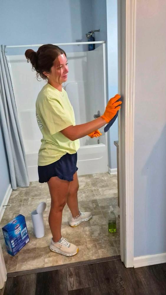 Volunteers cleaning a bedroom together